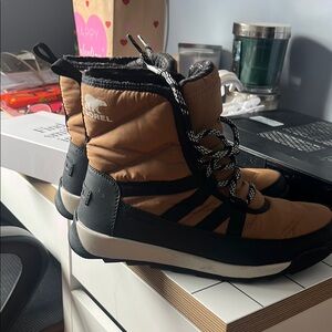Sorel Tan and Black Ankle Boots with Lace-Up Design and Insulation